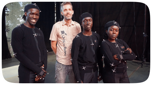 An image that has four people out which three are wearing motion capture suits